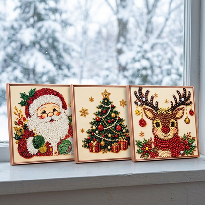 Santa, Tree and Reindeer pictures in matching frames on a snowy windowsill