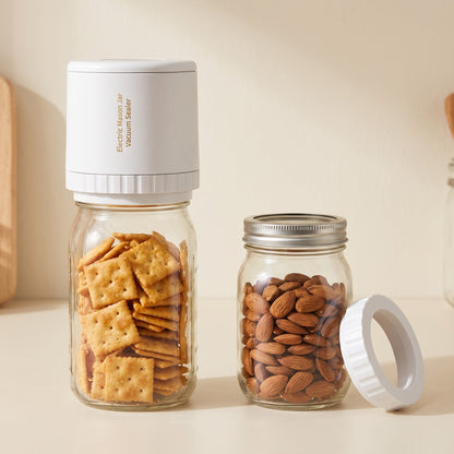 The sealer with its adapter ring next to wide-mouth and regular-mouth Mason jars