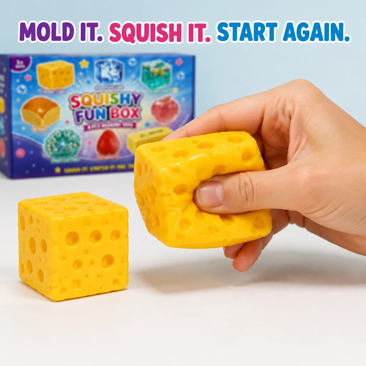 A hand pressing and reshaping the cheese cube squishy